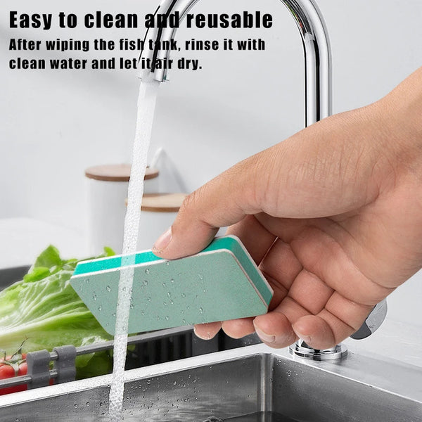 A hand is rinsing a teal fish tank cleaning brush under running water in a kitchen sink.