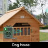 A wooden dog house with an ultrasonic anti-barking device attached to the front.