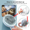 A hand is using a white pet hair removal brush to easily remove hair from a cat's fur.
