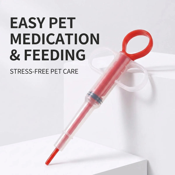 A red pet medicine syringe dispenser with a clear cap is shown on a white surface.