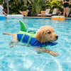 A golden retriever wearing a bright green and blue life vest swims in a pool.