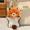 An orange cartoon fox bean bag plush toy with white ears and a rainbow design, hanging from a light beige tote bag.