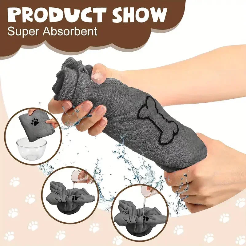 A hand is holding a gray absorbent pet bath towel shaped like a dog bone, demonstrating its absorbency.