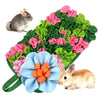 A mat featuring colorful fabric flowers and leaves designed for interactive pet foraging with small animals.