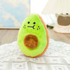 A bright green avocado plush toy with a brown center resting on a white lace cloth.