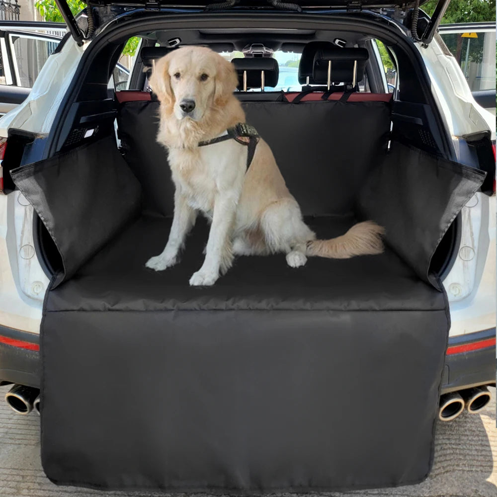 A golden retriever sits on a black waterproof dog car seat cover inside a vehicle.