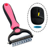 A pink and black two-sided pet grooming brush with a flexible silicone comb and a storage case.