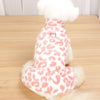 A white dog dress with a leopard print pattern and a fluffy white collar.