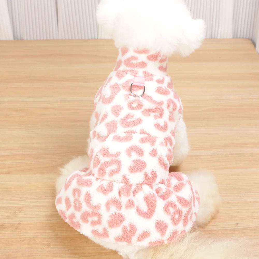 A white dog dress with a leopard print pattern and a fluffy white collar.