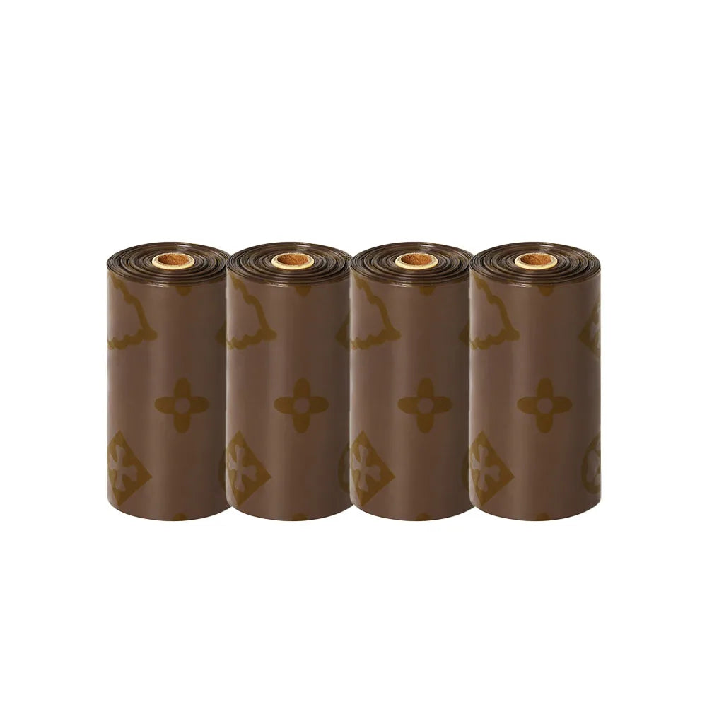 A set of brown biodegradable scented dog poop bags rolled up and displayed side by side.