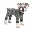 A small dog wearing a striped four-legged jumpsuit with soft polyester fabric.