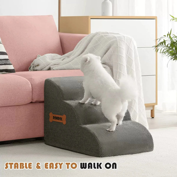 A white pet is walking on gray foam stairs with a white non-slip cover in a bright living room setting.