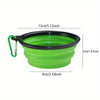 A bright lime green silicone dog travel bowl with a black rim and green carrying loop.