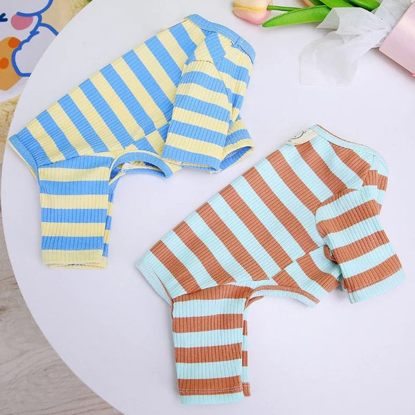 Two striped knitted garments, one yellow and blue, and one brown and orange, laid out on a white surface.
