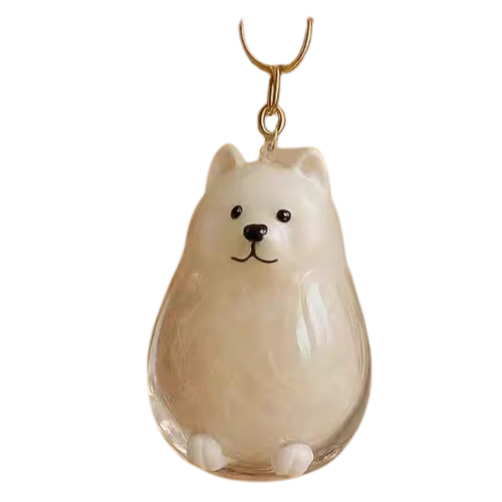 Un colgante en forma de pera de un perro de dibujos animados con un lazo colgante de color dorado.