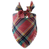 A plaid dog bandana in shades of red, brown, black, and teal with fringed edges.