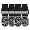 A set of four black anti-slip dog socks with leopard print paw protection and white wrist bands.