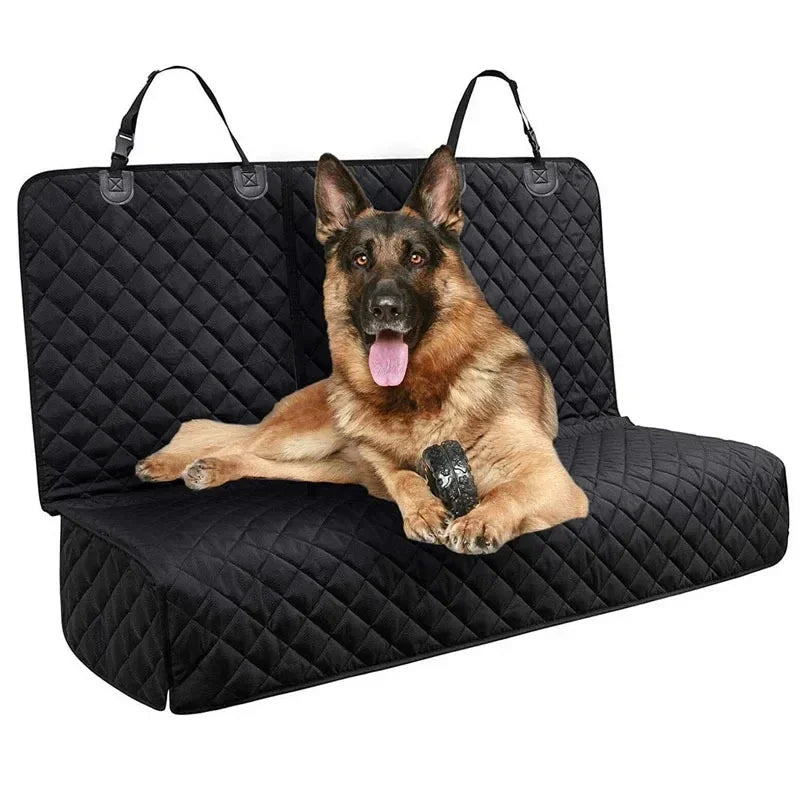 A German Shepherd dog lying on a black quilted waterproof car seat cover.