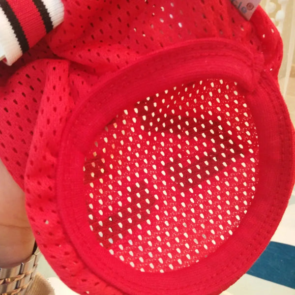 A close-up of a red breathable mesh dog basketball costume with a perforated surface.