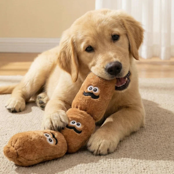 A golden retriever puppy lies on a rug next to a brown plush sausage dog chew toy.