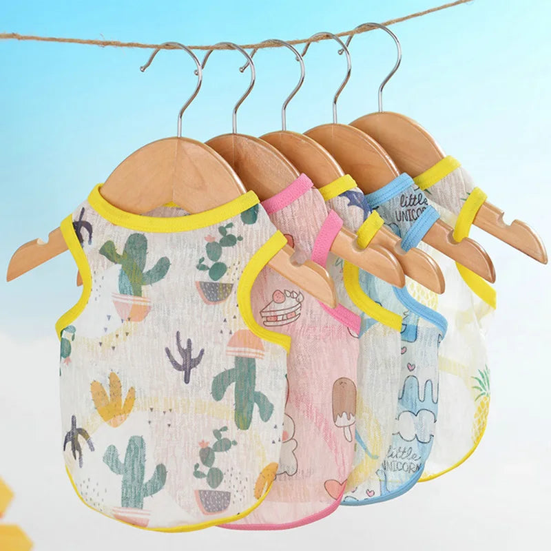 A collection of breathable summer mesh vests for small dogs and cats hanging on a clothesline.