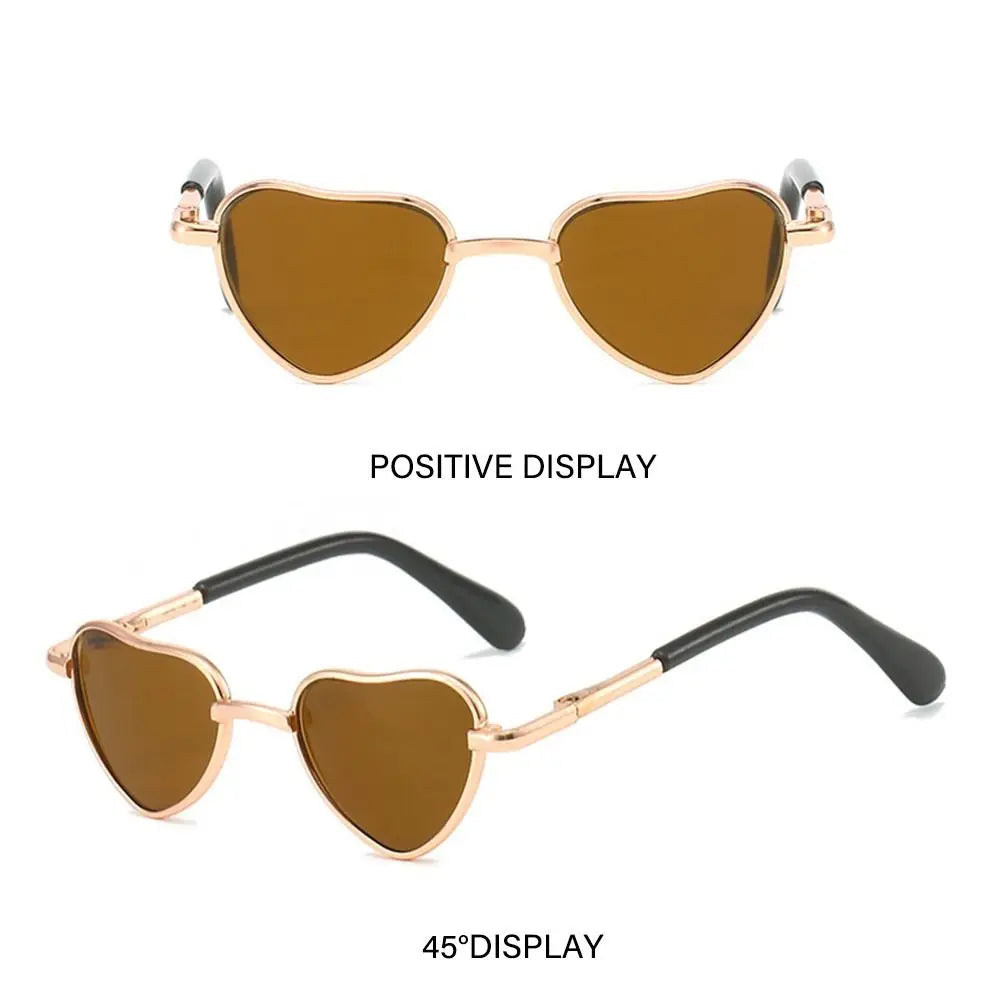 A pair of gold-toned heart-shaped pet sunglasses shown in positive and 45 degree displays.