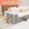 A self-adhesive cat scratching mat protecting a fabric sofa, with a cat playing on the mat.