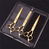 A set of professional stainless steel pet grooming scissors and a comb displayed in a black zippered case.