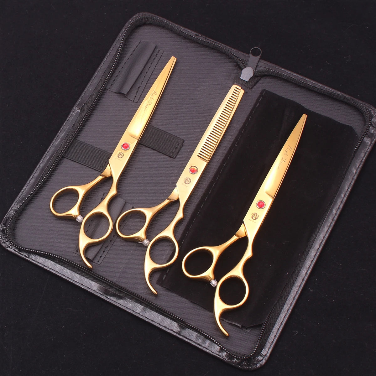 A set of professional stainless steel pet grooming scissors and a comb displayed in a black zippered case.