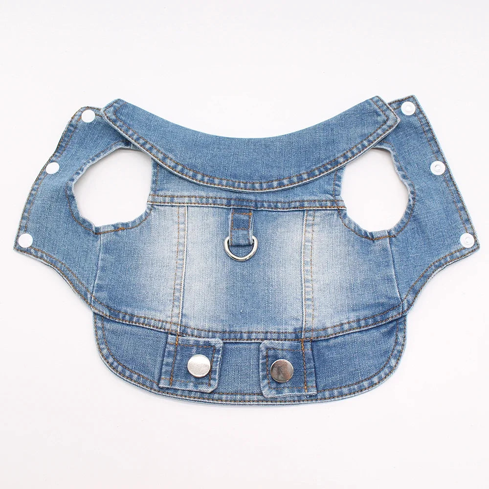 A light blue denim dog jacket with a D-ring leash attachment.