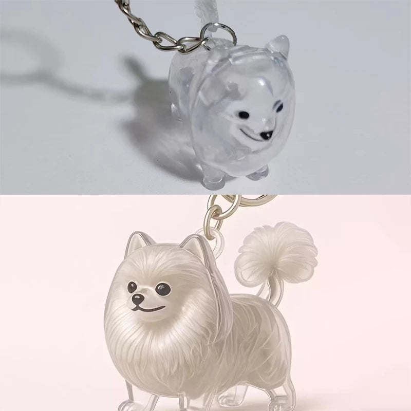 Klares Harzkeychain mit einer geschnitzten weißen Welpenkopf mit langem Fell und flauschigem Schwanz.
