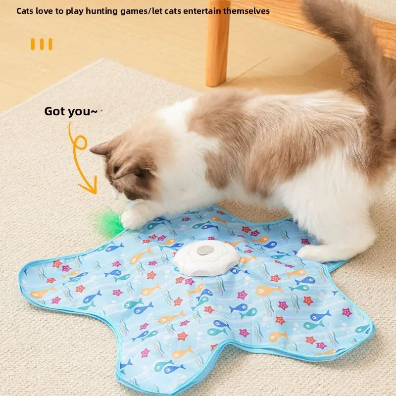 A light blue silicone cat toy with colorful feathers is shown on a beige surface.