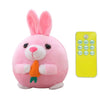 A pink rabbit plush toy with long ears and an orange nose, next to a yellow electronic device.