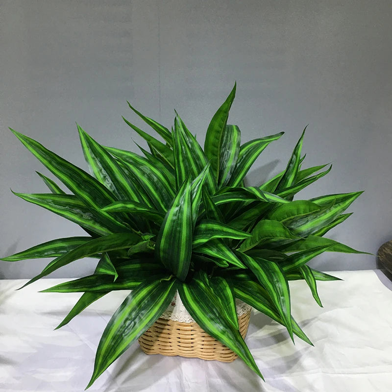A vibrant green artificial tropical palm plant with long, spiky leaves displayed on a white surface.