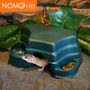 A reptile hide cave decoration featuring a plastic container with food bowls and a small lizard inside.