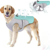 A golden retriever wearing a light blue evaporative cooling dog vest with a reflective harness, showing water spray effects.