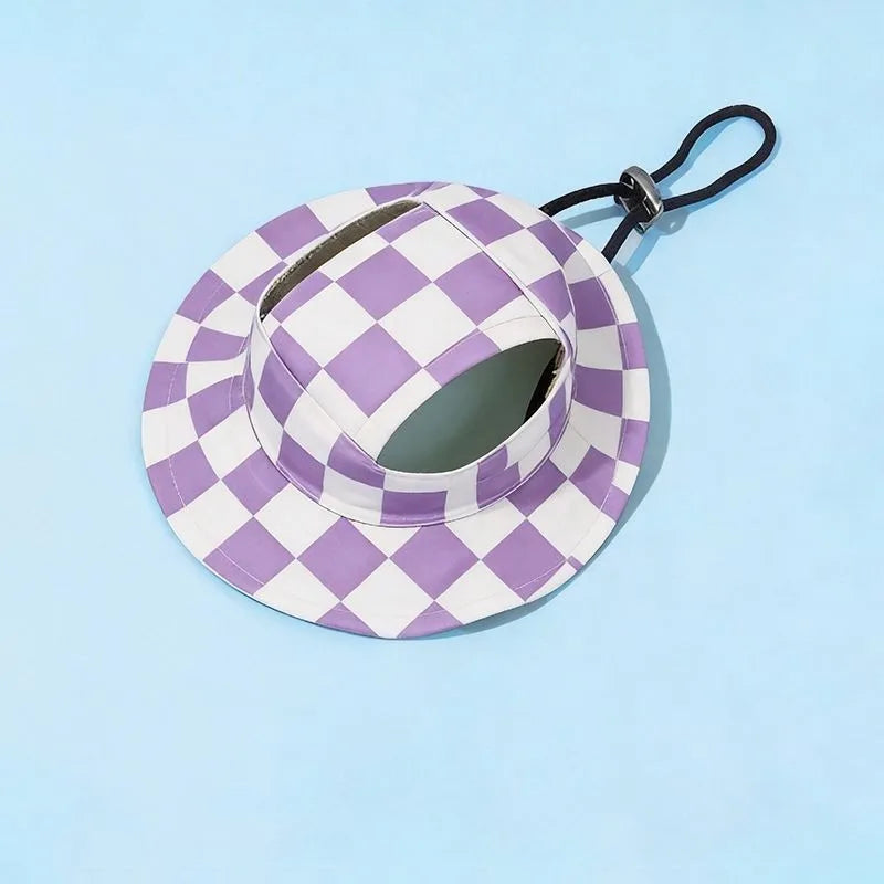 A purple and white checkered bucket hat with a black strap is shown against a light blue background.