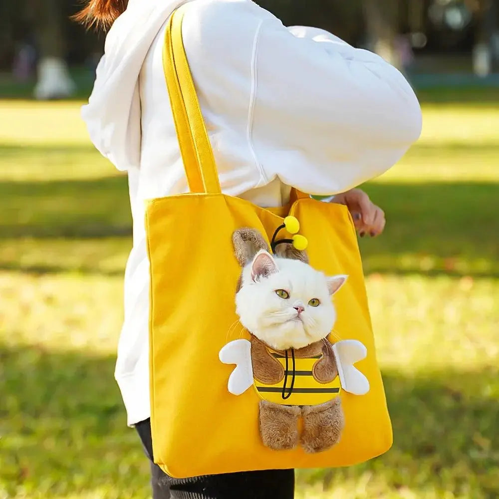 A yellow portable crossbody pet carrier bag featuring a cute cat plush toy.