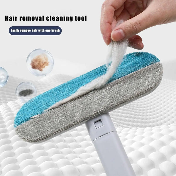 A hand is using a blue and gray hair removal cleaning tool to remove hair from a surface.