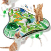 A cat toy featuring colorful feathers and leaves, with a kitten interacting with the toy.