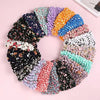 A circular arrangement of colorful, textured fabric or material resembling a reusable foldable bubble shopping bag.