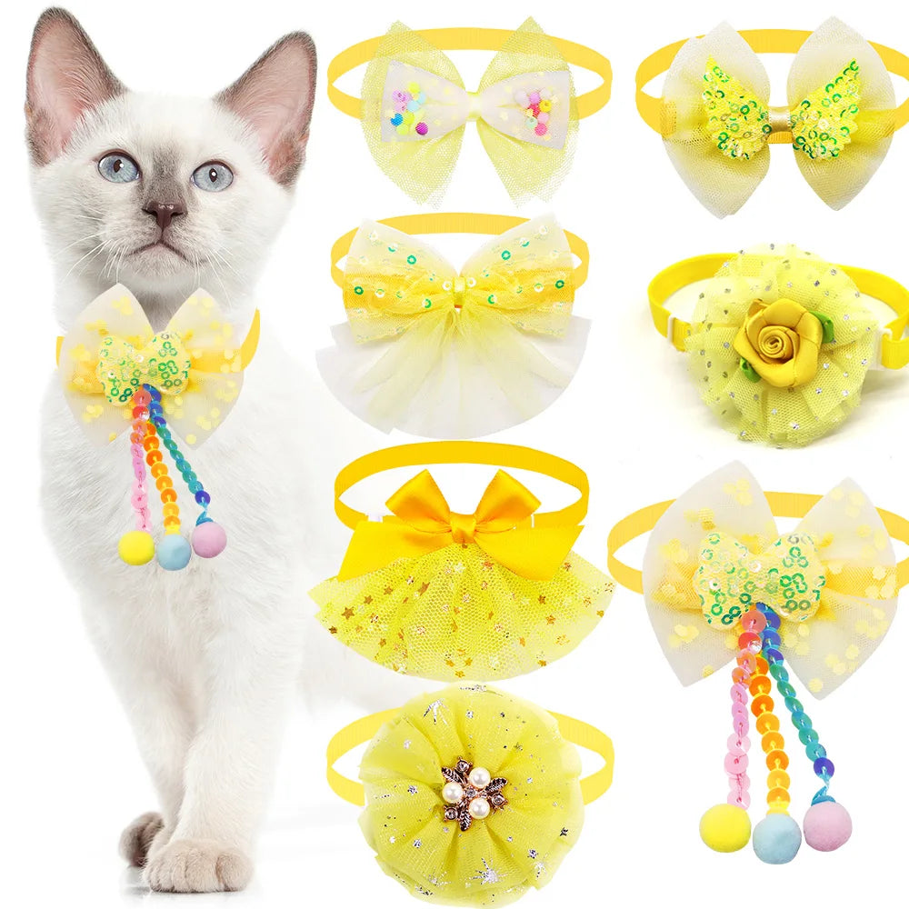 Yellow and white lace bowtie collar accessories for cats featuring various floral and sparkly designs