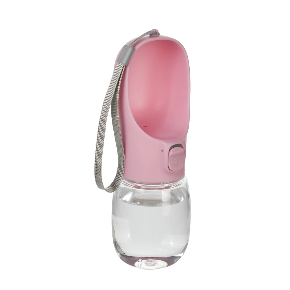 A pink portable leakproof dog water bottle with a built-in bowl and a strap.