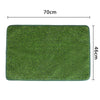 A rectangular green dog grass mat measuring 70cm by 46cm.