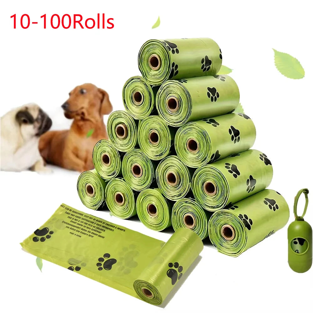 A stack of 10 to 100 rolls of biodegradable pet poop bags in light green with black paw prints, next to a dog and an open bag