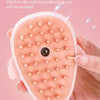 A pink bathing and massage brush with a soft brush head is shown being held by a hand.