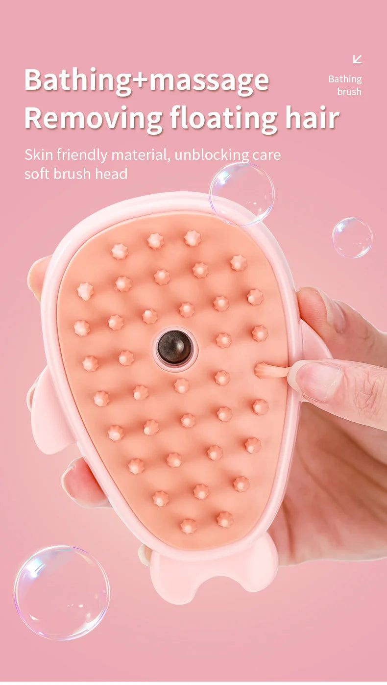 A pink bathing and massage brush with a soft brush head is shown being held by a hand.