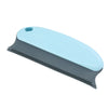 A light blue and gray reusable pet hair remover brush with a small hole on the handle.