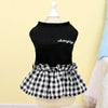 Black top and black and white checkered skirt displayed on a mannequin.