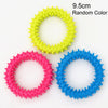 Three rings of squeaky chew toys for dogs in yellow, pink, and blue.